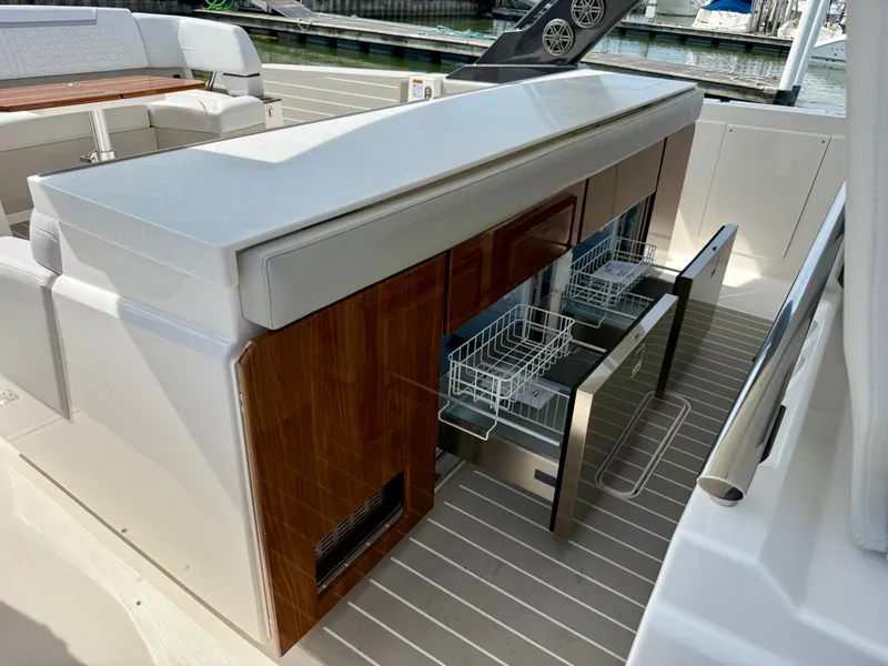 Slide: The Image of The 2027 Tiara Yachts 43LS features a modern outdoor kitchen with drawers and a dishwasher. - 22
