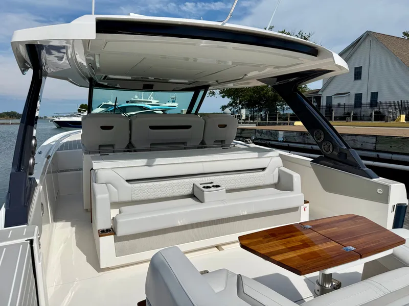 Slide: The Image of The image shows the spacious cockpit of a 2027 Tiara Yachts 43LS with elegant seating and a wooden table. - 6