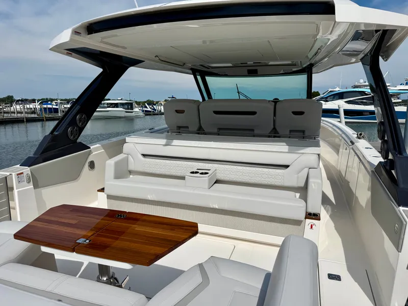 Slide: The Image of The image shows the cockpit of a 2027 Tiara Yachts 43LS with sleek white seating and a wooden table. - 3