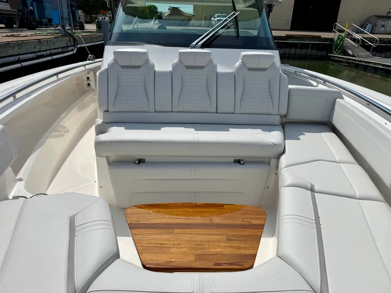 Slide: The Image of The image shows the elegant seating area of a 2027 Tiara Yachts 43LS with white upholstery. - 20