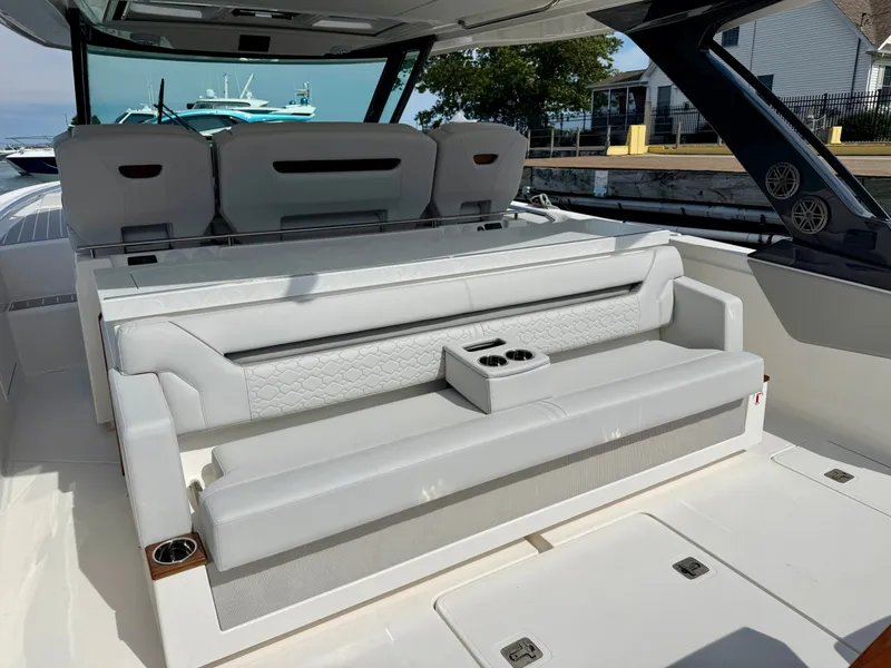 Slide: The Image of The image shows the cockpit of a Tiara Yachts 43LS with sleek white seating and cup holders. - 11