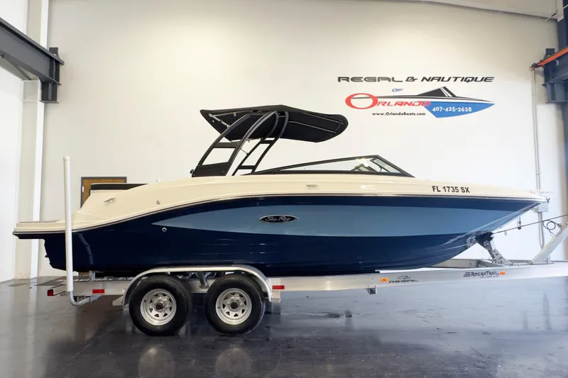 The Image of 2021 Sea Ray SPX 230 boat on trailer in showroom, side view. - 0