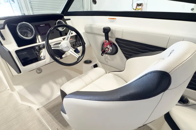 Slide: The Image of 2021 Sea Ray SPX 230 boat interior with steering wheel and dashboard controls. - 10
