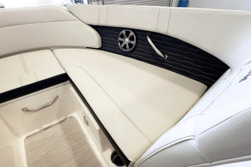 Slide: The Image of Interior seating of 2021 Sea Ray SPX 230 boat with white upholstery and speaker. - 14