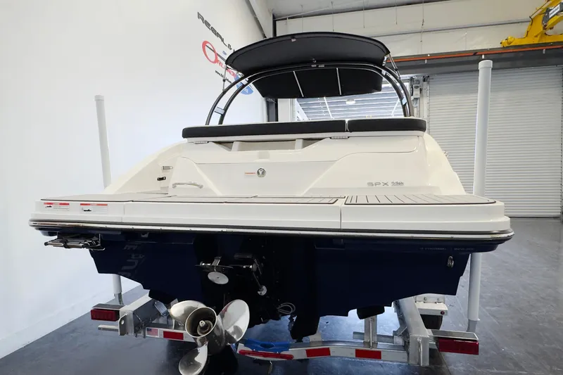 Slide: The Image of 2021 Sea Ray SPX 230 boat on trailer in indoor storage facility. - 3