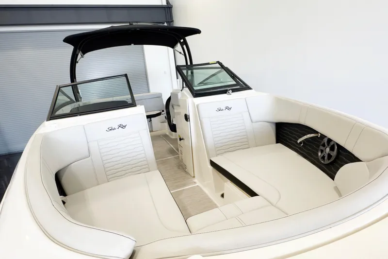 Slide: The Image of 2021 Sea Ray SPX 230 boat interior with white seating and sleek design. - 5