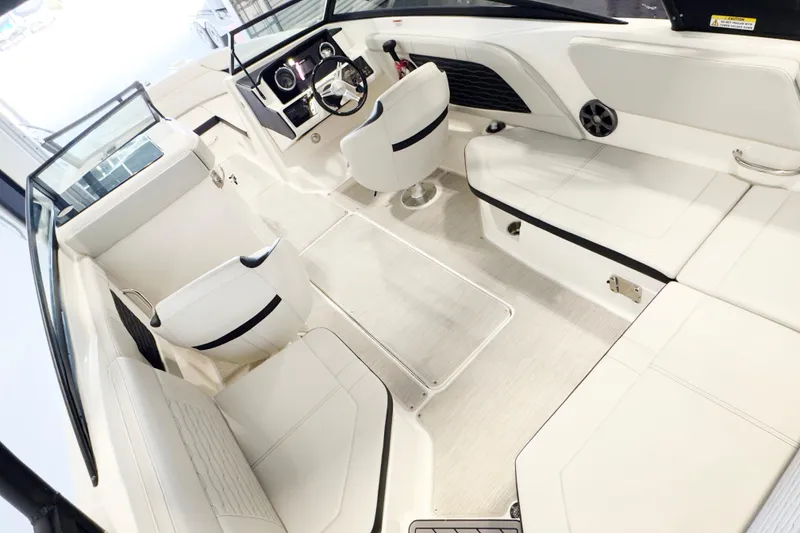 Slide: The Image of Interior of a 2021 Sea Ray SPX 230 boat with white seating and modern dashboard. - 7