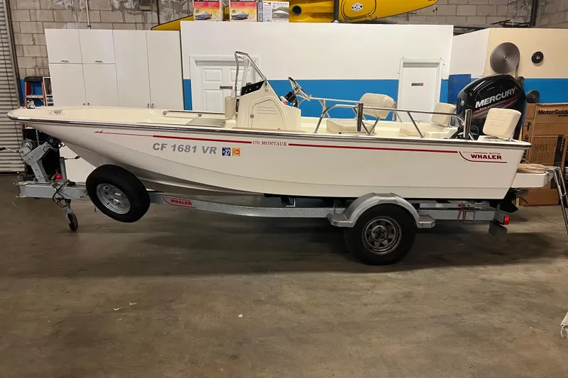 The Image of 2019 Boston Whaler 170 Montauk boat on trailer in garage setting. - 0