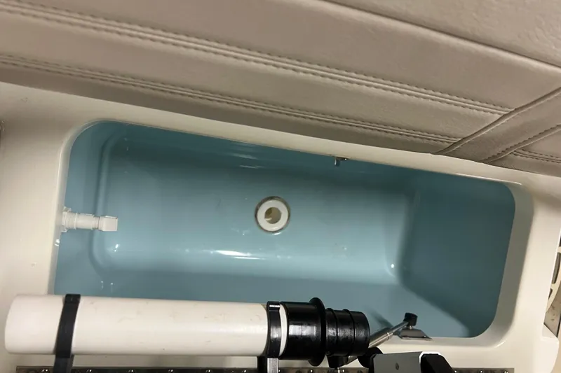 Slide: The Image of Livewell compartment in a 2019 Boston Whaler 170 Montauk boat, featuring a blue interior. - 12