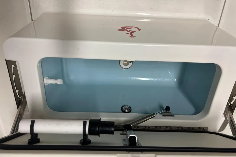 Slide: The Image of 2019 Boston Whaler 170 Montauk livewell with open lid and visible plumbing. - 13