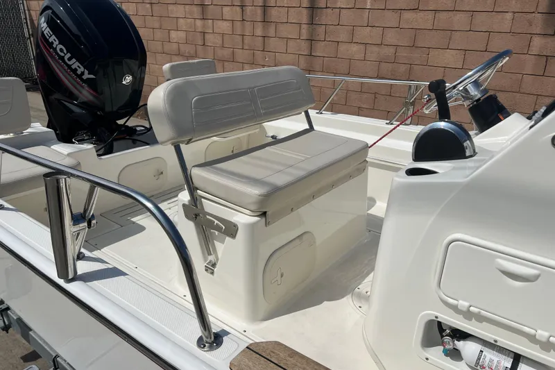 Slide: The Image of 2019 Boston Whaler 170 Montauk boat interior with Mercury engine and seating. - 19