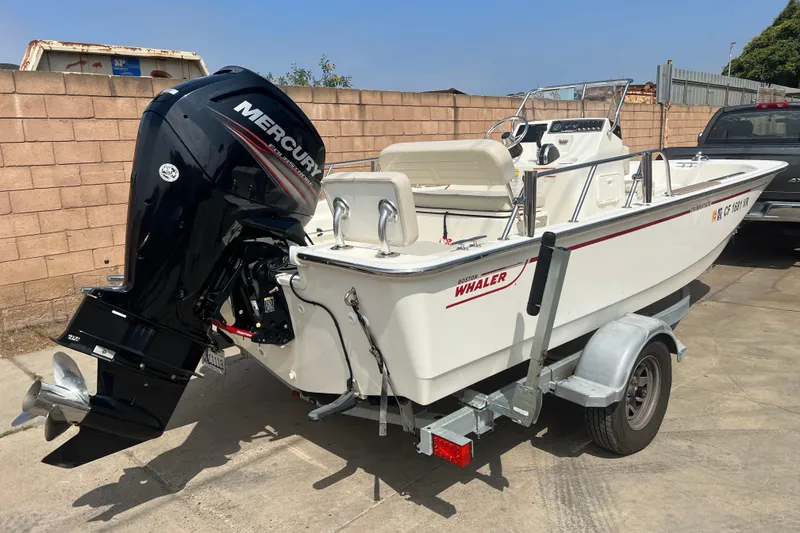 Slide: The Image of 2019 Boston Whaler 170 Montauk boat with Mercury engine on trailer. - 21