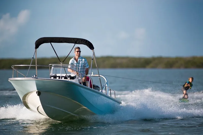 Slide: The Image of Manufacturer Provided Image: 2019 Boston Whaler 170 Montauk boat towing a wakeboarder on a sunny day. - 27