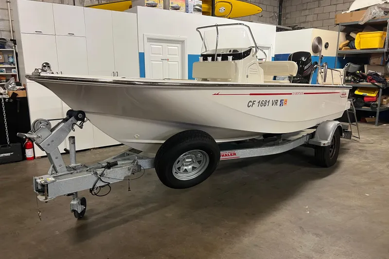 Slide: The Image of 2019 Boston Whaler 170 Montauk boat on trailer in garage setting. - 3