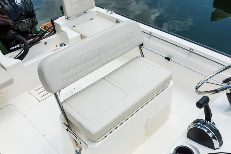 Slide: The Image of Manufacturer Provided Image: 2019 Boston Whaler 170 Montauk boat interior with cushioned seating and steering console. - 38