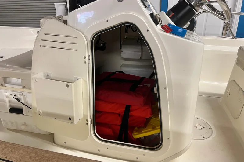 Slide: The Image of 2019 Boston Whaler 170 Montauk boat storage compartment with life jackets and equipment. - 5