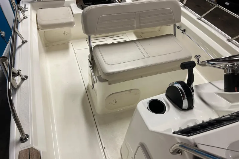 Slide: The Image of 2019 Boston Whaler 170 Montauk interior with seating and control console. - 8