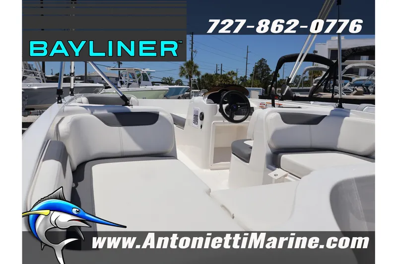 Slide: The Image of 2026 Bayliner Element E18 boat interior with seating, steering wheel, and marine logo. - 5