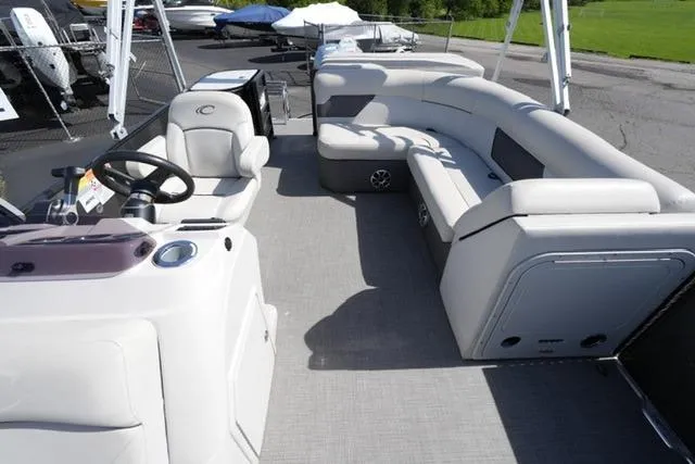 Slide: The Image of 2021 Crest Classic DLX 200 L pontoon boat interior with seating and steering console. - 11