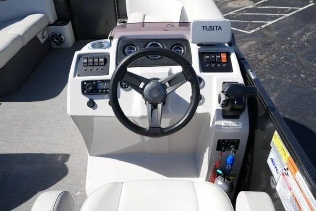 Slide: The Image of Cockpit of 2021 Crest Classic DLX 200 L pontoon boat with steering wheel and controls. - 13