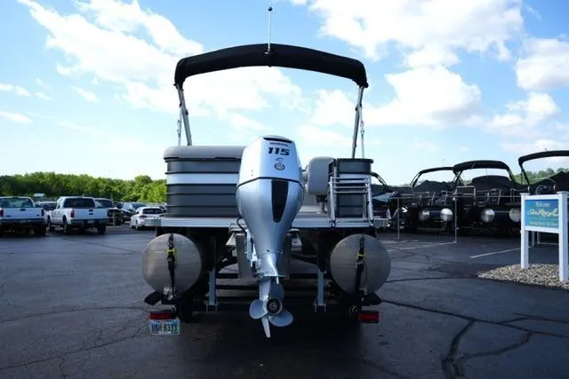 Slide: The Image of 2021 Crest Classic DLX 200 L pontoon boat with 115 HP engine, parked outdoors. - 6
