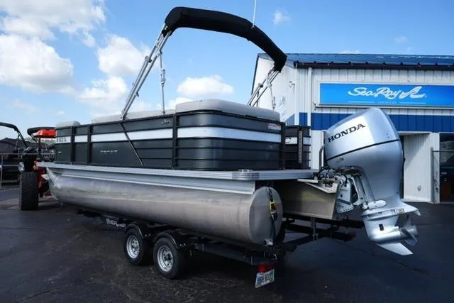 Slide: The Image of 2021 Crest Classic DLX 200 L pontoon boat with Honda outboard motor on trailer. - 7