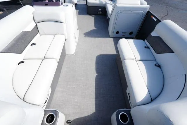 Slide: The Image of 2021 Crest Classic DLX 200 L pontoon boat interior with white seating and cup holders. - 9