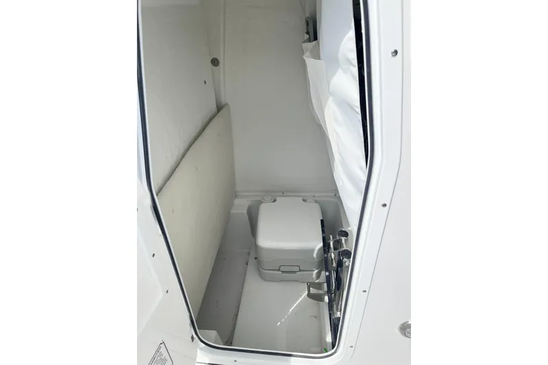 Slide: The Image of Interior of 2026 Sea Hunt Ultra 235 SE boat with compact toilet. - 11