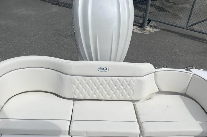 Slide: The Image of 2026 Sea Hunt Ultra 235 SE boat with white cushioned seating and sleek design. - 13