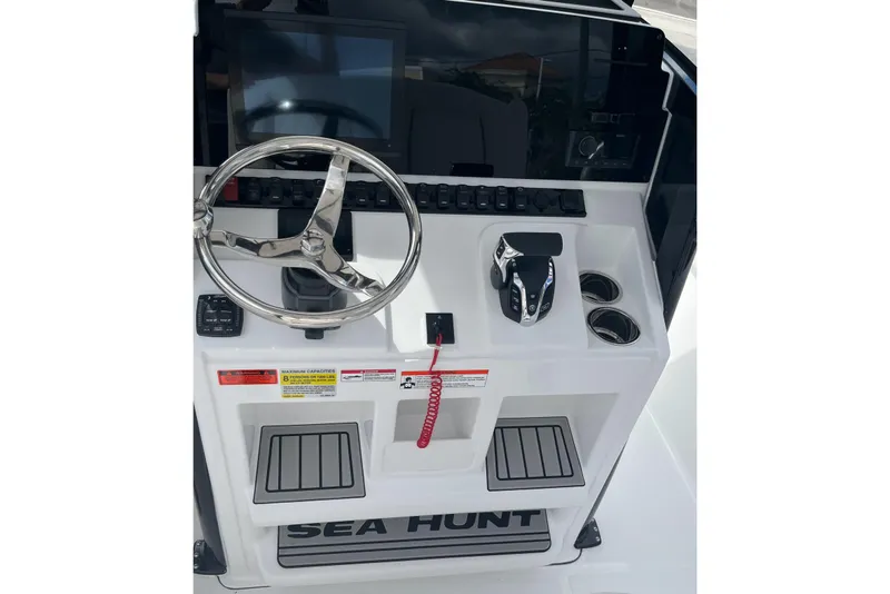 Slide: The Image of Steering console of 2026 Sea Hunt Ultra 235 SE boat with controls and display. - 14
