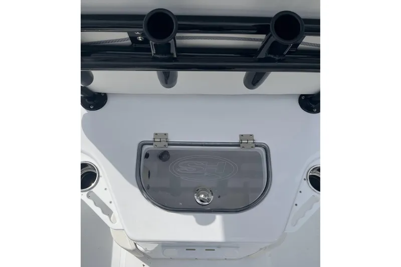 Slide: The Image of 2026 Sea Hunt Ultra 235 SE boat interior with rod holders and storage compartment. - 15