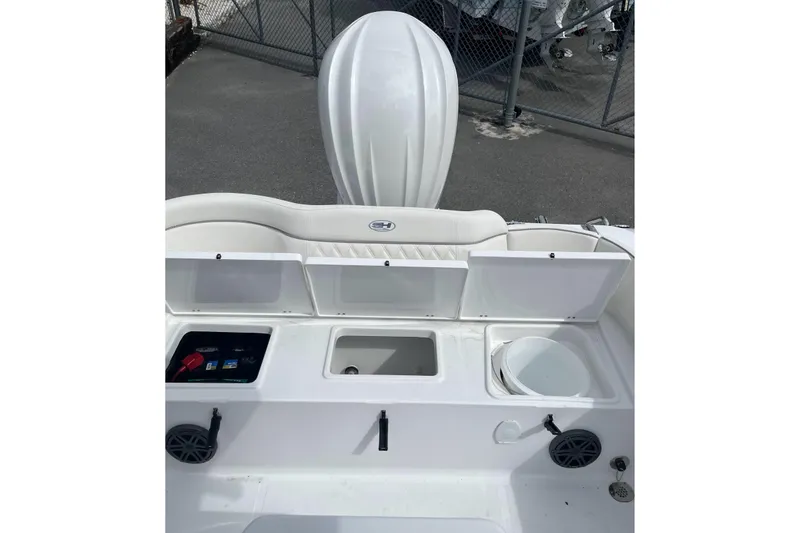 Slide: The Image of 2026 Sea Hunt Ultra 235 SE boat interior with storage compartments open. - 17