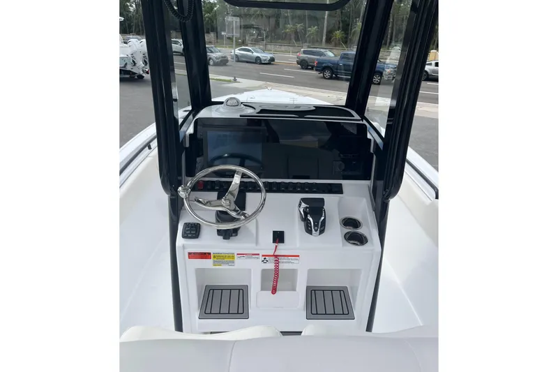 Slide: The Image of 2026 Sea Hunt Ultra 235 SE boat dashboard with steering wheel and controls. - 19