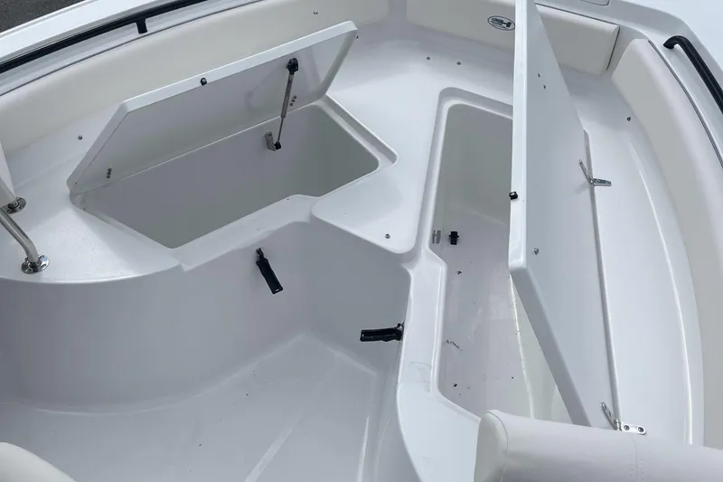 Slide: The Image of 2026 Sea Hunt Ultra 235 SE boat interior with open storage compartments. - 21