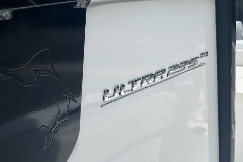Slide: The Image of 2026 Sea Hunt Ultra 235 SE boat emblem on sleek white surface. - 24