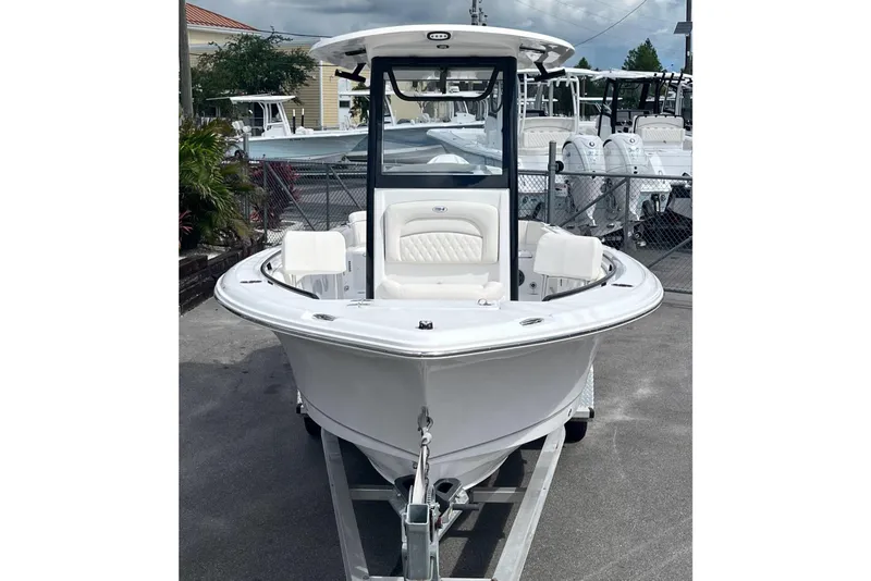 Slide: The Image of 2026 Sea Hunt Ultra 235 SE boat on trailer, front view, in a marina setting. - 3