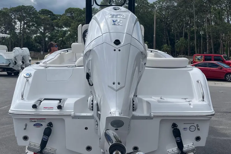 Slide: The Image of 2026 Sea Hunt Ultra 235 SE boat with powerful outboard motor in a marina setting. - 6