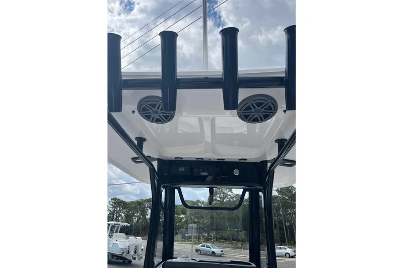 Slide: The Image of T-top view of 2026 Sea Hunt Ultra 235 SE boat with rod holders and speakers. - 9