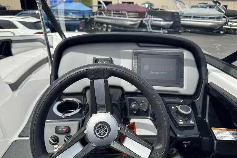 Slide: The Image of 2020 Yamaha Boats SX240 dashboard with steering wheel and control panel. - 11