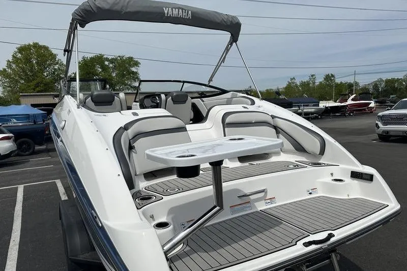 Slide: The Image of 2020 Yamaha Boats SX240 with seating and table, parked outdoors. - 12
