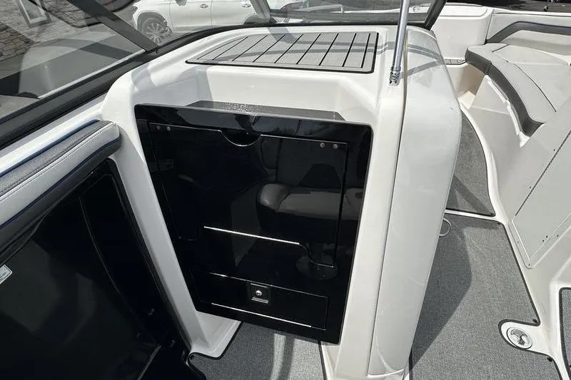 Slide: The Image of 2020 Yamaha Boats SX240 interior with sleek black panel and seating area. - 24