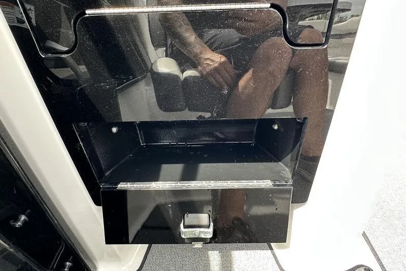 Slide: The Image of 2020 Yamaha Boats SX240 interior storage compartment with reflective surface and visible seating. - 26