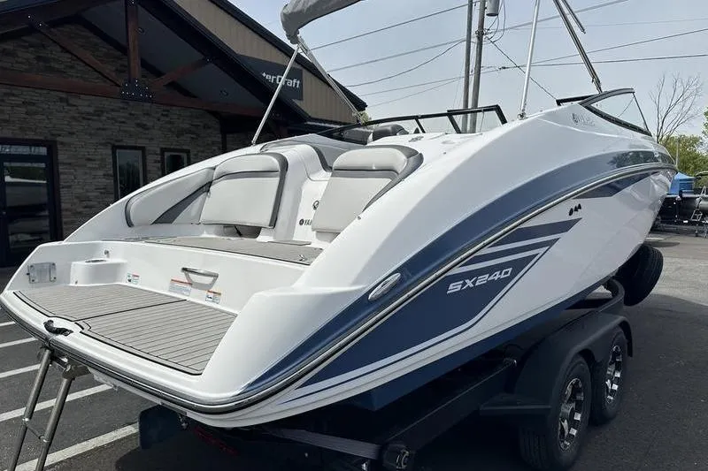 Slide: The Image of 2020 Yamaha Boats SX240 on trailer, showcasing sleek design and spacious seating. - 3