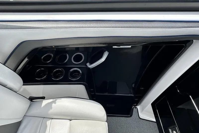Slide: The Image of Interior of 2020 Yamaha Boats SX240, featuring cup holders and seating area. - 30