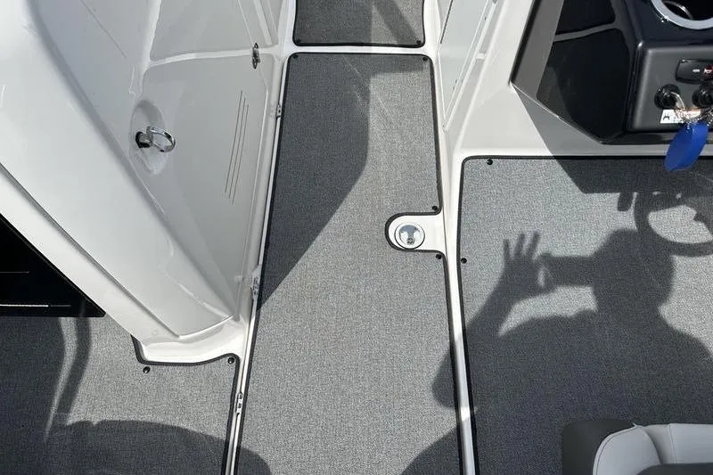Slide: The Image of 2020 Yamaha Boats SX240 interior with gray carpet and control panel. - 42