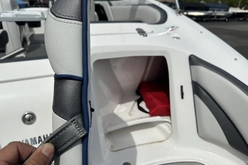 Slide: The Image of 2020 Yamaha Boats SX240 interior with storage compartment and safety equipment. - 5