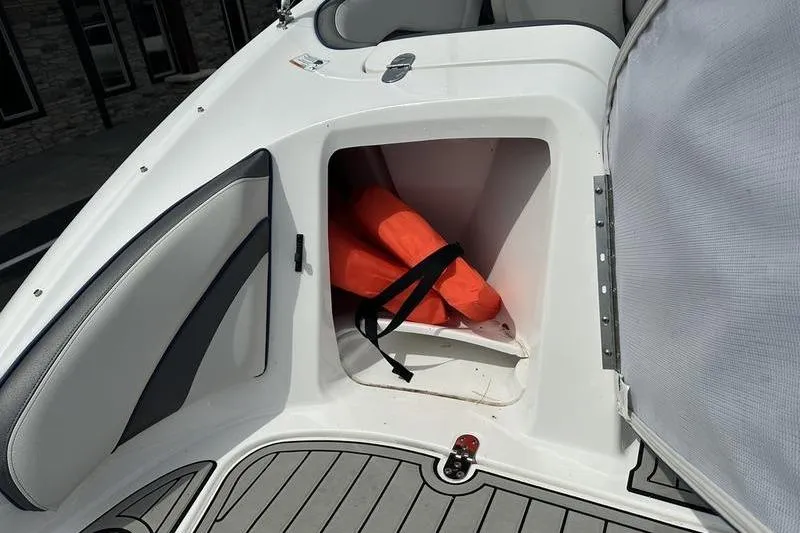 Slide: The Image of 2020 Yamaha SX240 boat storage compartment with orange life jackets. - 6