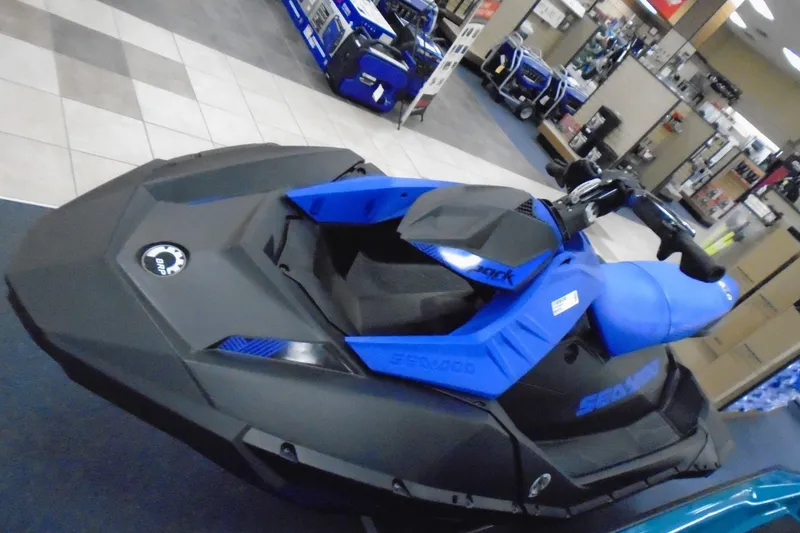 The Image of 2023 Sea-Doo Spark Trixx 3up in showroom, featuring sleek blue and black design. - 0