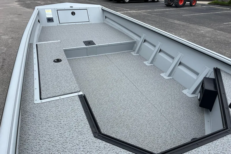 Slide: The Image of 2026 SeaArk DXS 1652 DKLD boat interior with spacious deck and storage compartments. - 11