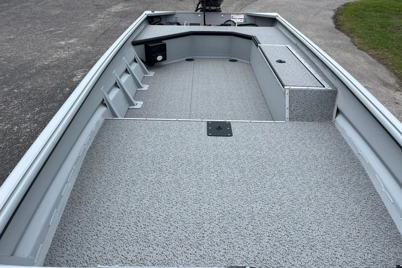 Slide: The Image of 2026 SeaArk DXS 1652 DKLD boat interior with textured flooring and storage compartments. - 13